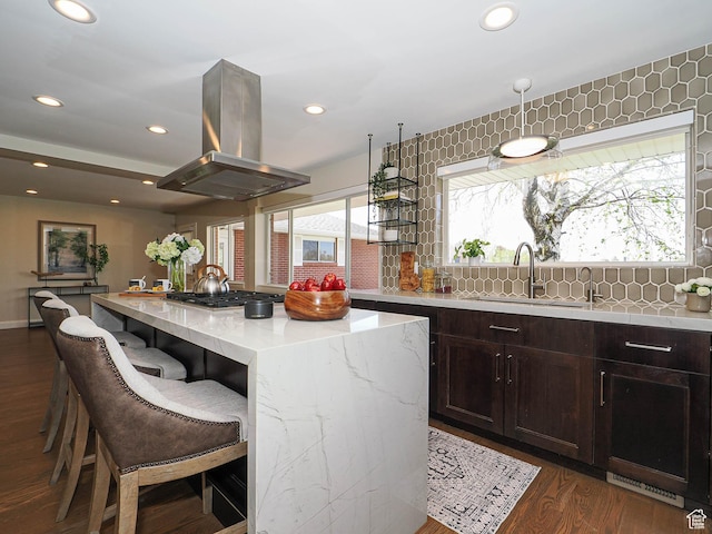 2463 E Michigan Ave S, Salt Lake City, UT 84108 - kitchen featuring island range hood, a sink, a kitchen island, decorative backsplash, and light stone countertops
