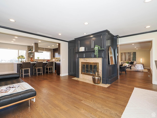 2463 E Michigan Ave S, Salt Lake City, UT 84108 - living area with a premium fireplace, wood finished floors, recessed lighting, baseboards, and crown molding