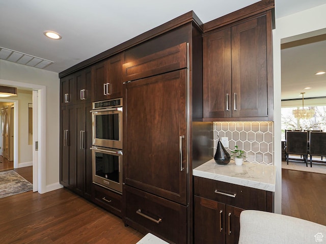 2463 E Michigan Ave S, Salt Lake City, UT 84108 - kitchen with double oven, dark wood finished floors, dark brown cabinets, tasteful backsplash, and recessed lighting