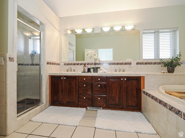 2463 E Michigan Ave S, Salt Lake City, UT 84108 - bathroom featuring tile patterned floors, a stall shower, tile walls, double vanity, and tiled tub