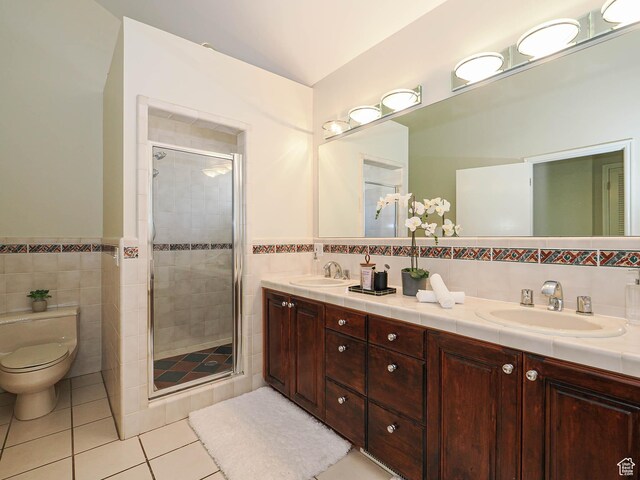 2463 E Michigan Ave S, Salt Lake City, UT 84108 - full bath featuring tile walls, tile patterned flooring, a stall shower, double vanity, and toilet