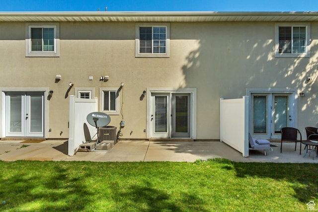 back of house featuring a patio area, french doors, and stucco siding