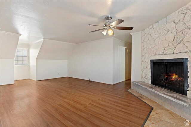 1202 E Mutton Hollow Rd, Kaysville, UT 84037 - unfurnished living room featuring a ceiling fan, wood finished floors, ornamental molding, and a stone fireplace