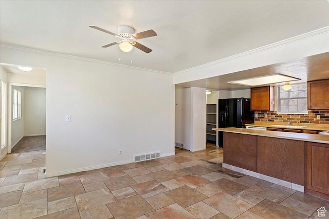 1202 E Mutton Hollow Rd, Kaysville, UT 84037 - kitchen with a ceiling fan, visible vents, stone finish flooring, light countertops, and brown cabinets