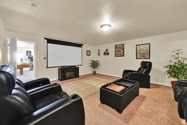home theater room with carpet flooring, baseboards, and visible vents