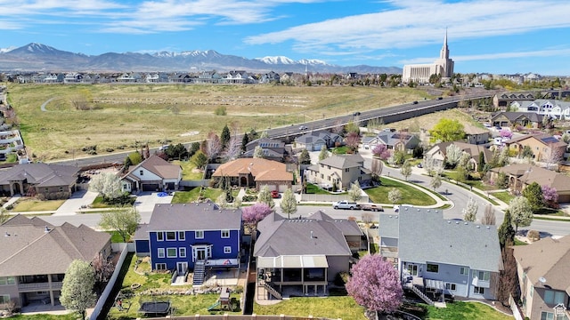 birds eye view of property with a mountain view and a residential view