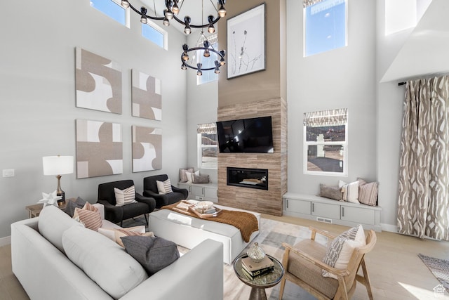 1026 W Chokecherry Dr Unit 135, Mapleton, UT 84664 - living area with a high ceiling, a chandelier, a fireplace, and light wood-style floors