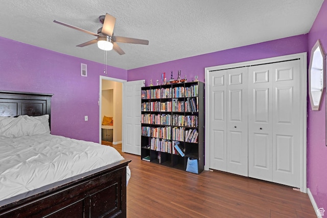 bedroom featuring visible vents, baseboards, a ceiling fan, a textured ceiling, and dark wood finished floors