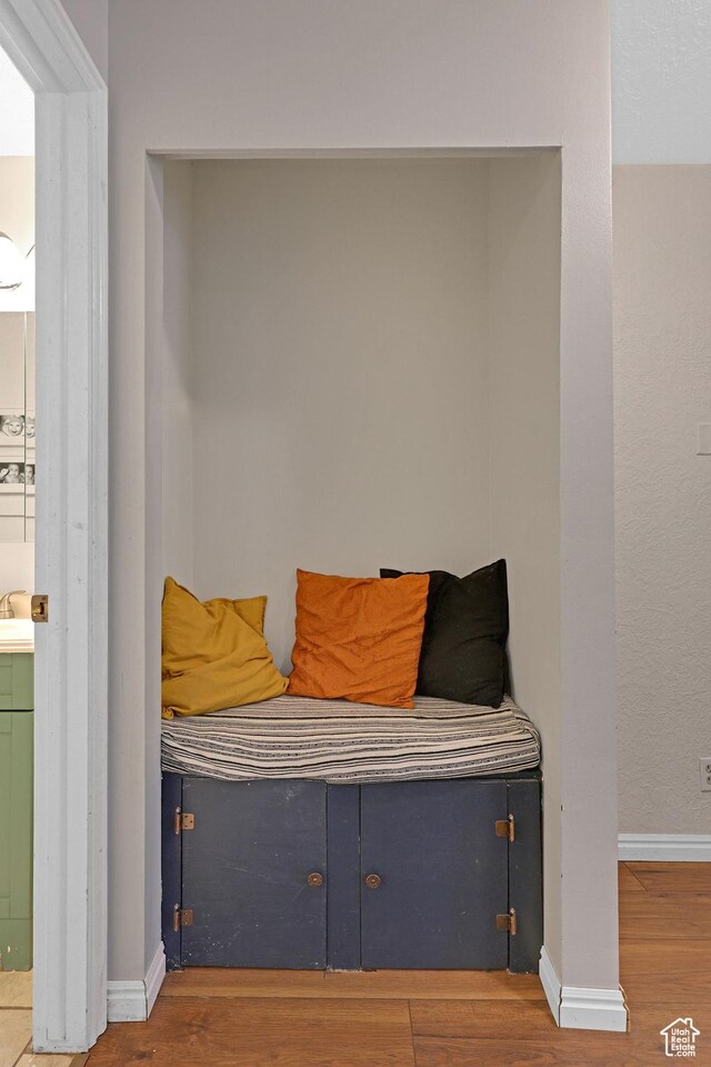 mudroom with baseboards and wood finished floors