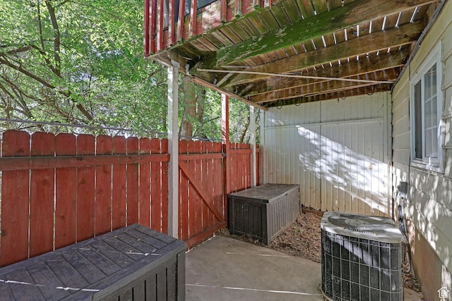view of patio featuring cooling unit and fence