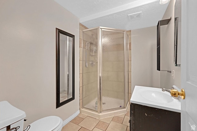 bathroom featuring vanity, tile patterned flooring, toilet, a shower stall, and visible vents