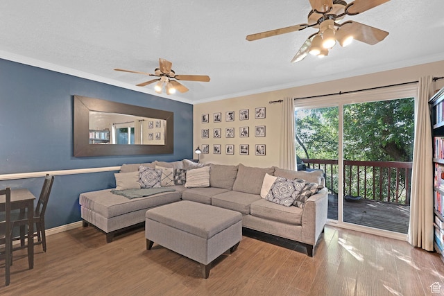 living room with crown molding, wood finished floors, ceiling fan, and a textured ceiling