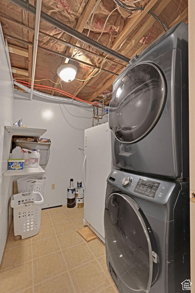 laundry area with tile patterned floors and stacked washer and clothes dryer