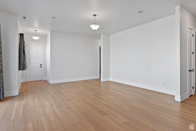 5648 S Adobe Sun Dr, St George, UT 84790 - unfurnished living room with visible vents, light wood-style flooring, and baseboards