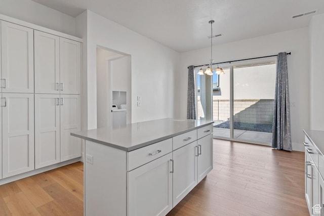 5648 S Adobe Sun Dr, St George, UT 84790 - kitchen featuring white cabinets, visible vents, light wood-type flooring, and an inviting chandelier