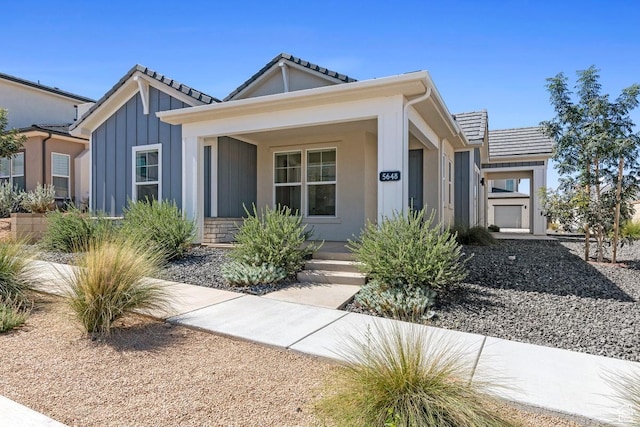 5648 S Adobe Sun Dr, St George, UT 84790 - bungalow-style house featuring stucco siding, a tiled roof, and covered porch