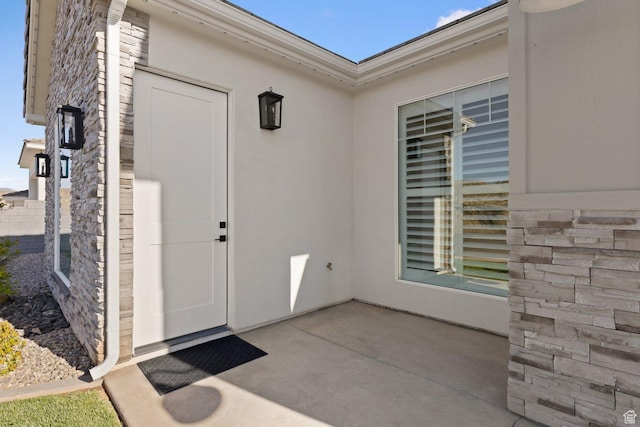 1624 W Chandler Dr, St George, UT 84770 - entrance to property featuring a patio area, stucco siding, and stone siding