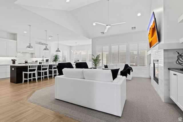 1624 W Chandler Dr, St George, UT 84770 - living room with a glass covered fireplace, a ceiling fan, recessed lighting, and lofted ceiling