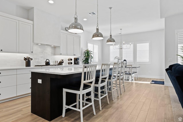 1624 W Chandler Dr, St George, UT 84770 - kitchen with a center island, recessed lighting, backsplash, light wood-style floors, and light countertops