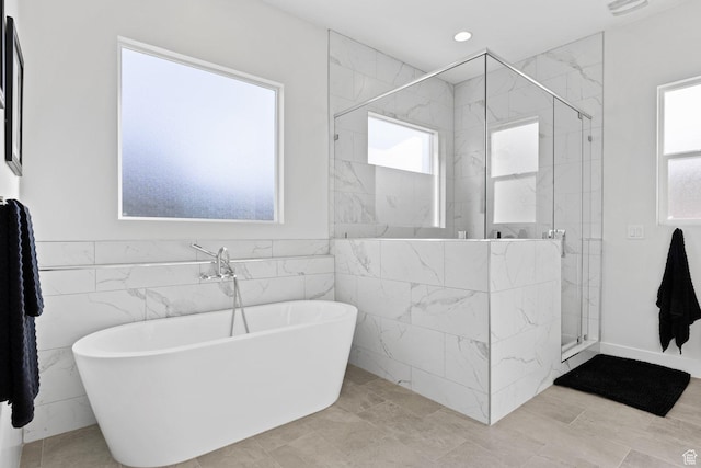 1624 W Chandler Dr, St George, UT 84770 - bathroom featuring healthy amount of natural light, a freestanding bath, tile walls, a stall shower, and recessed lighting