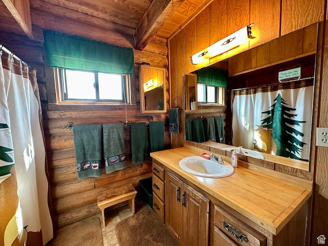 2947 S Chukar Dr, Garden City, UT 84028 - full bathroom with log walls, plenty of natural light, vanity, a wooden ceiling with exposed beams, and a shower with shower curtain
