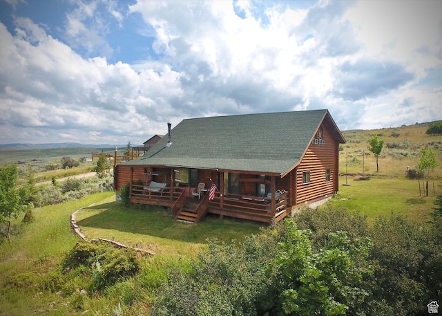 2947 S Chukar Dr, Garden City, UT 84028 - back of property featuring a lawn, a deck, log exterior, and a rural view