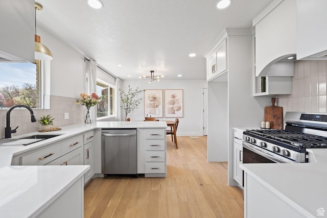 205 S Highland Dr, Santaquin, UT 84655 - kitchen featuring stainless steel appliances, light countertops, a sink, and backsplash