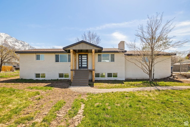 205 S Highland Dr, Santaquin, UT 84655 - view of front facade featuring a chimney, fence, a front lawn, and brick siding