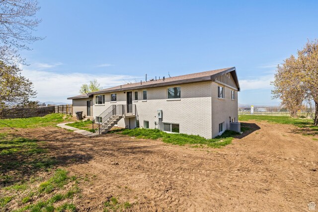 205 S Highland Dr, Santaquin, UT 84655 - rear view of property with brick siding, central air condition unit, and fence