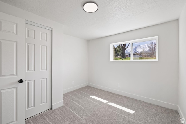 205 S Highland Dr, Santaquin, UT 84655 - unfurnished bedroom featuring baseboards, light colored carpet, and a textured ceiling