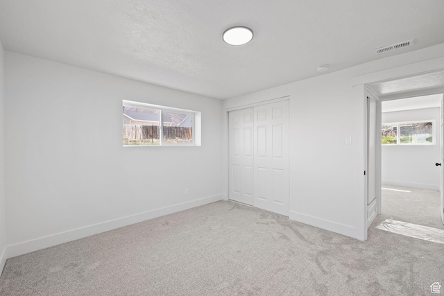 205 S Highland Dr, Santaquin, UT 84655 - unfurnished bedroom with a closet, baseboards, visible vents, and carpet floors