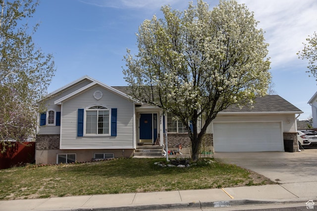 4345 S Long Valley Dr W, West Valley City, UT 84128 - view of front of property featuring a front yard, brick siding, a garage, and concrete driveway