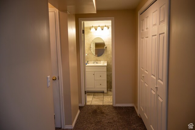 4345 S Long Valley Dr W, West Valley City, UT 84128 - hallway featuring light colored carpet, a sink, and baseboards