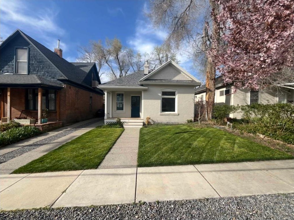 1161 E Bueno Ave, Salt Lake City, UT 84102 - bungalow-style home featuring a chimney, covered porch, a front yard, and brick siding