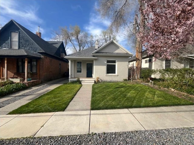1161 E Bueno Ave, Salt Lake City, UT 84102 - bungalow-style home featuring a chimney, covered porch, a front yard, and brick siding