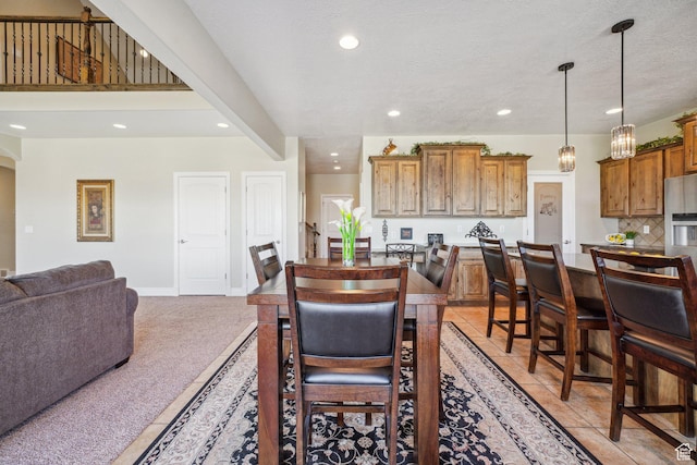 dining space featuring baseboards, recessed lighting, and light colored carpet