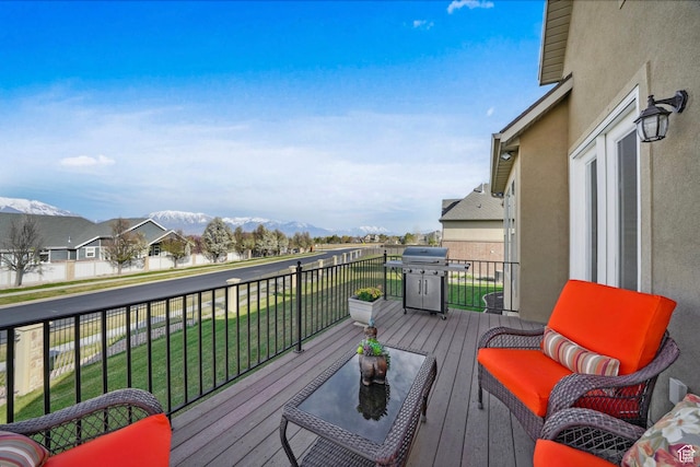 wooden terrace featuring a mountain view and area for grilling