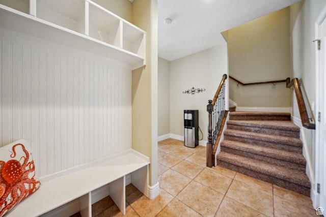 mudroom featuring light tile patterned floors and baseboards