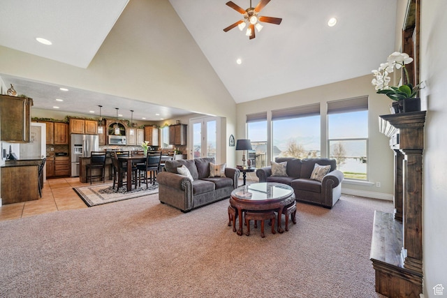 living area with baseboards, ceiling fan, recessed lighting, high vaulted ceiling, and light colored carpet