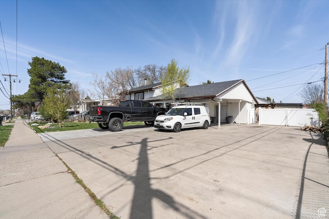 view of front of home featuring fence and a gate