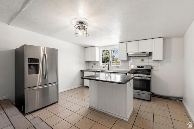 kitchen featuring a sink, white cabinets, under cabinet range hood, and stainless steel appliances