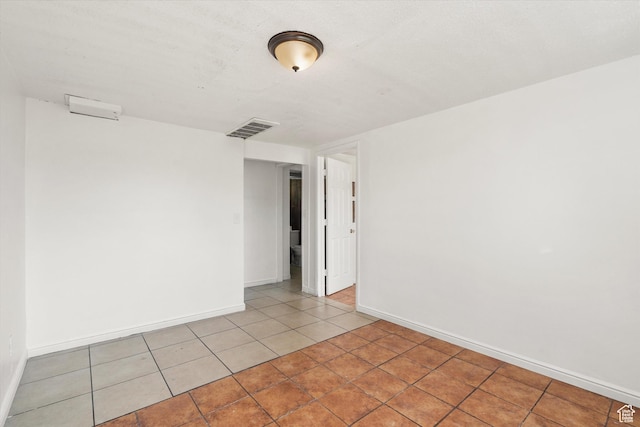 spare room with visible vents, baseboards, and light tile patterned flooring