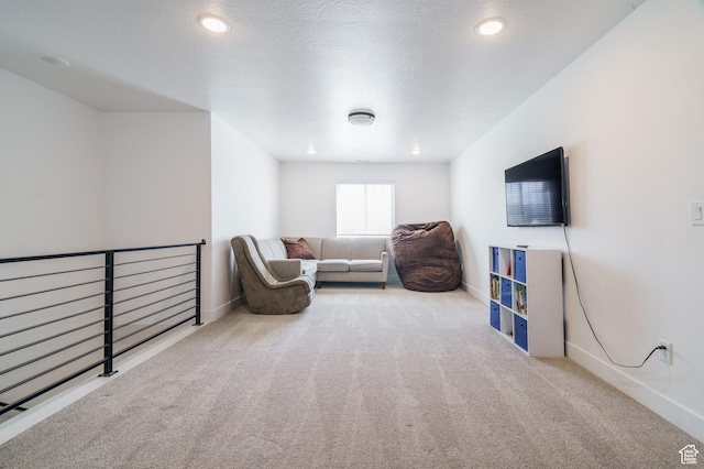 living area featuring an upstairs landing, baseboards, carpet, and recessed lighting