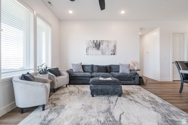 living area featuring baseboards, recessed lighting, a ceiling fan, visible vents, and wood finished floors