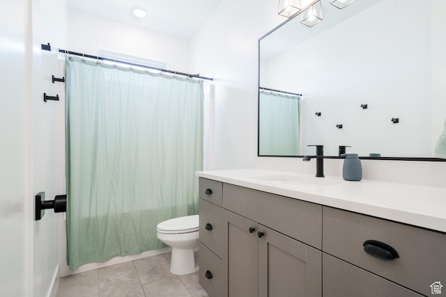 bathroom featuring tile patterned floors, vanity, and toilet