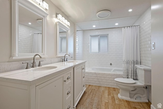 816 E 16th Ave, Salt Lake City, UT 84103 - full bath with toilet, tiled shower / bath, a sink, and wood finished floors