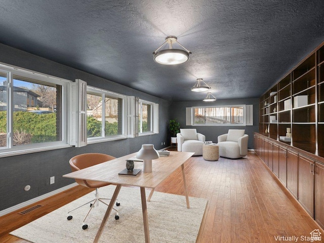 816 E 16th Ave, Salt Lake City, UT 84103 - interior space with a healthy amount of sunlight, light wood finished floors, a textured ceiling, and visible vents