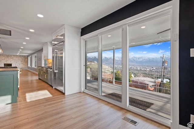 816 E 16th Ave, Salt Lake City, UT 84103 - doorway with visible vents, recessed lighting, light wood-style flooring, and a mountain view