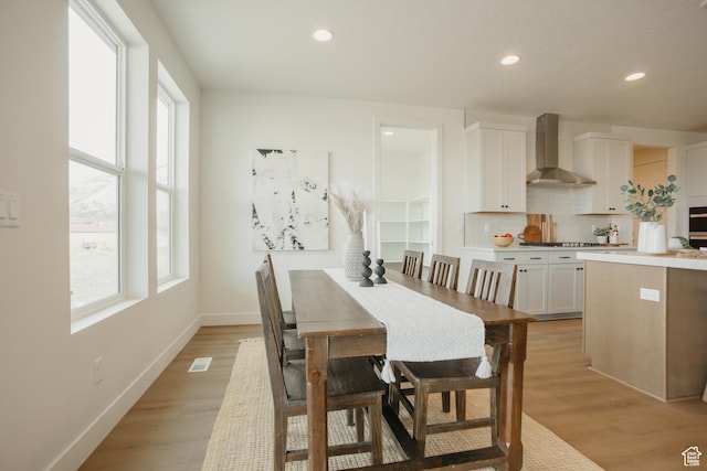 dining area with light wood-style floors, recessed lighting, and visible vents