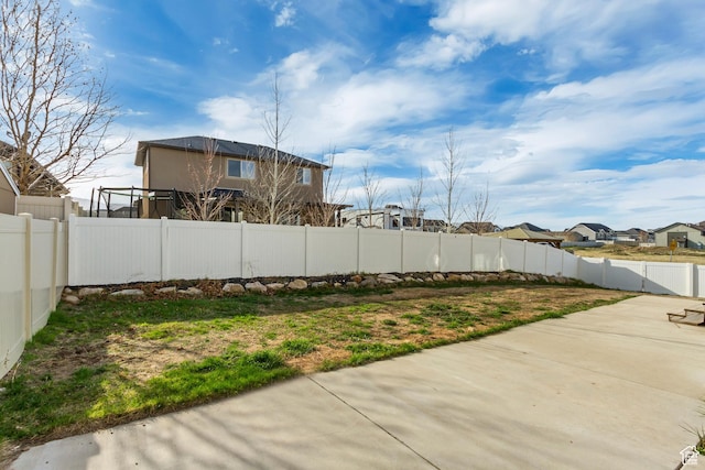 9452 S Alane Hollow Rd W, West Jordan, UT 84081 - view of yard featuring a fenced backyard, a patio, and a residential view